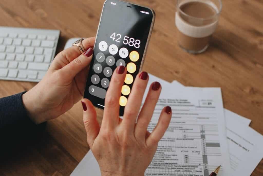 A person calculating tax on mobile